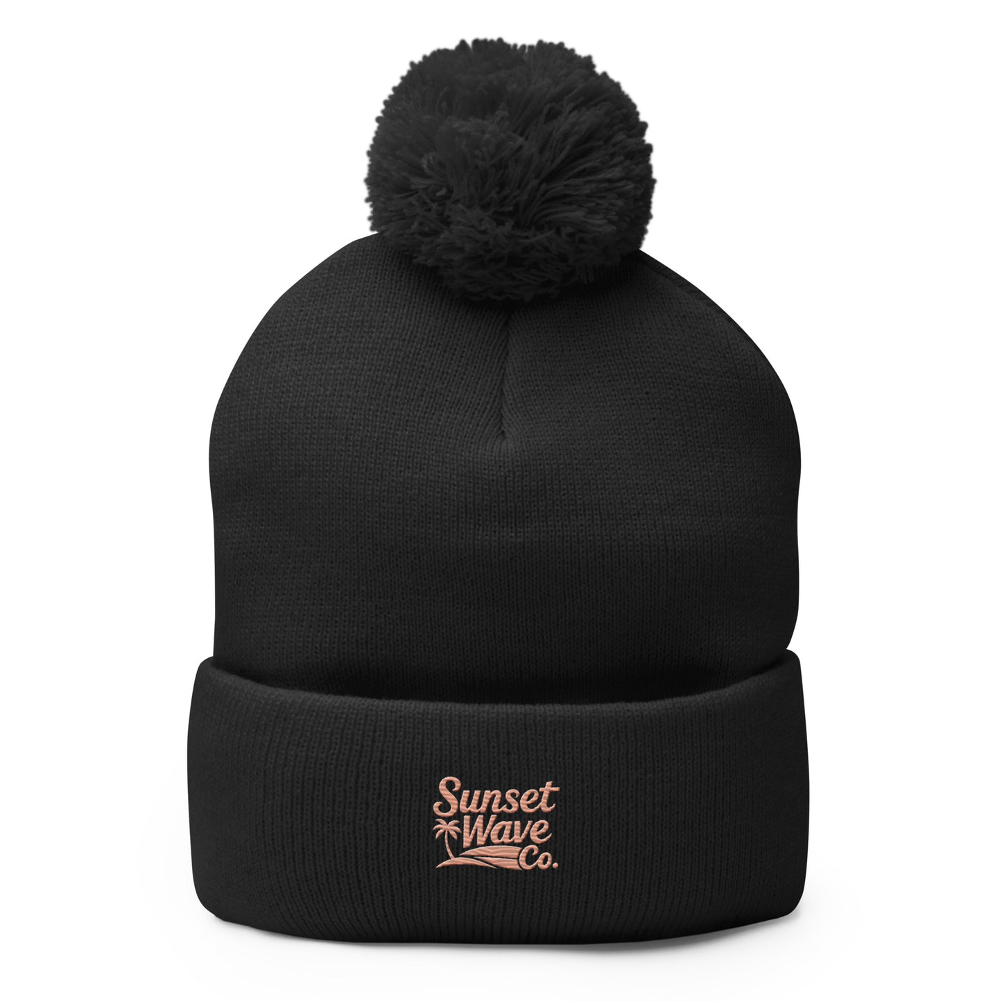 Black knit pom-pom beanie with folded brim and pink Sunset Wave Co. logo