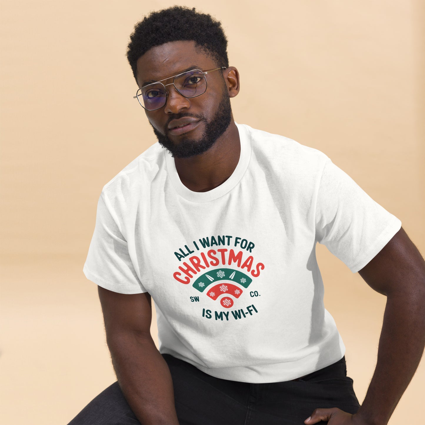 Man wearing white Christmas-themed tee with text All I want for Christmas is my Wi-Fi in red and green