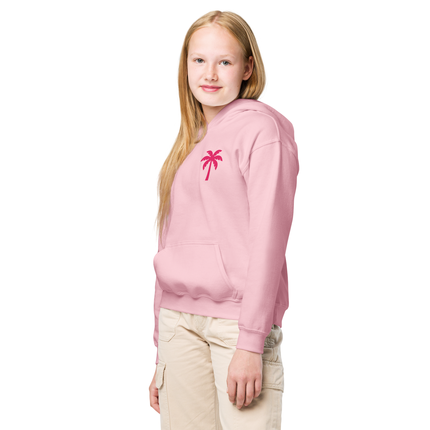 Teen girl wearing light pink hoodie with red palm tree print and beige cargo pants
