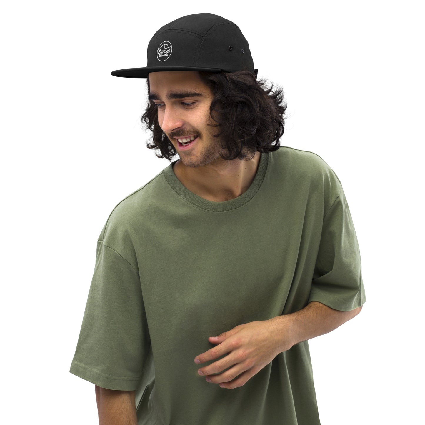Smiling man wearing black 5-panel cap with white logo and olive green T-shirt on white background