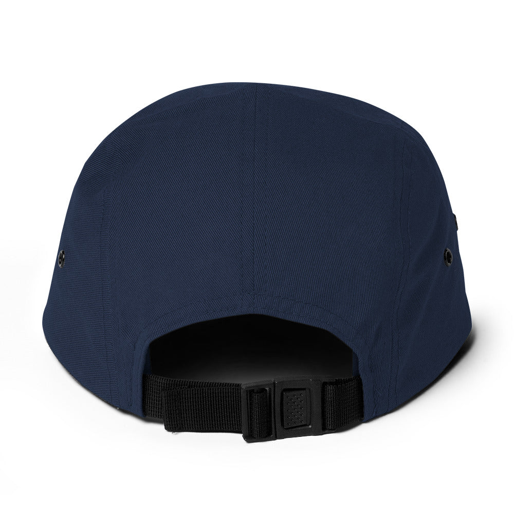 Back view of navy blue 5-panel cap with black adjustable strap and plastic buckle on white background