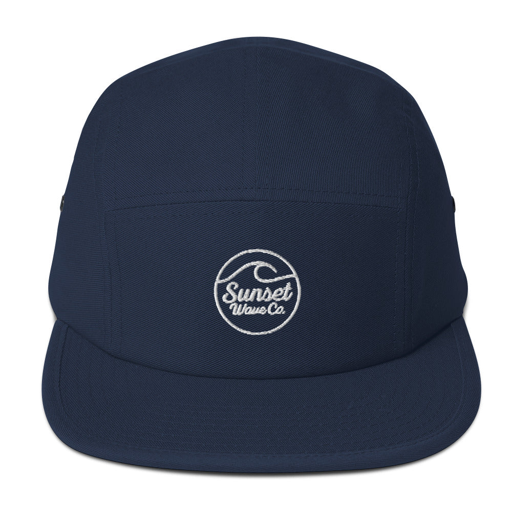 Navy blue 5-panel cap with white embroidered Sunset Wave Co. logo on front