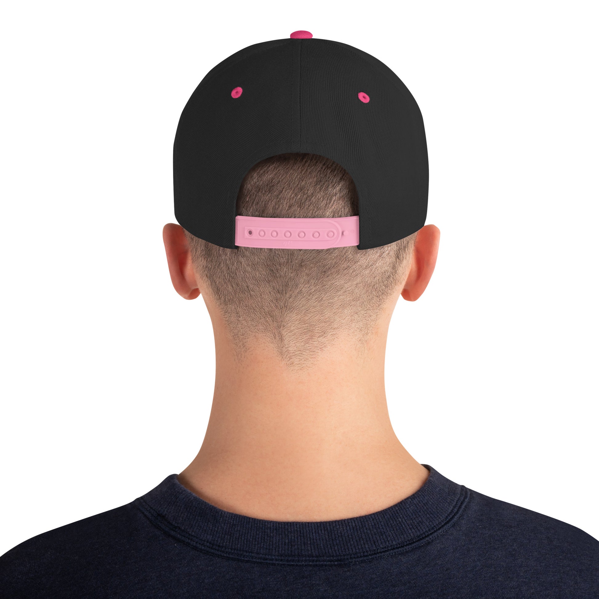 Back view of a person wearing a black snapback hat with neon pink adjustable strap and eyelets
