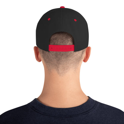 Back view of person wearing black snapback cap with red adjustable strap and red eyelets