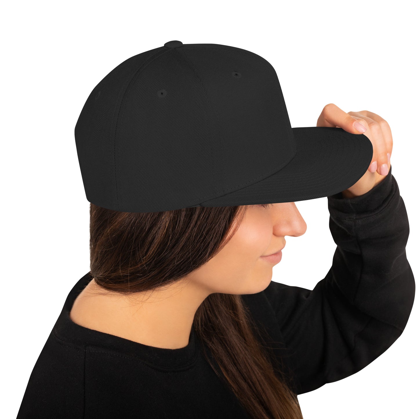 Woman wearing black classic snapback hat holding the brim on white background