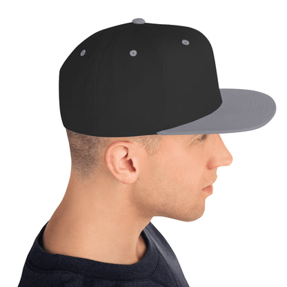 Side view of a man wearing a classic black snapback hat with a flat gray brim and gray eyelets
