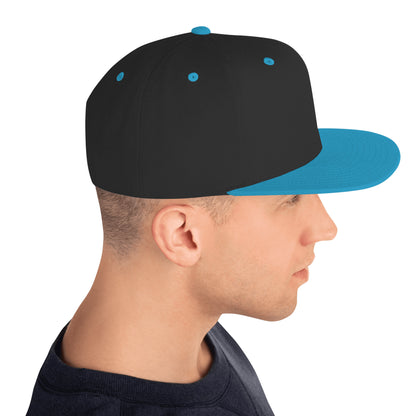 Side view of a man wearing a classic black snapback hat with teal brim and teal eyelets