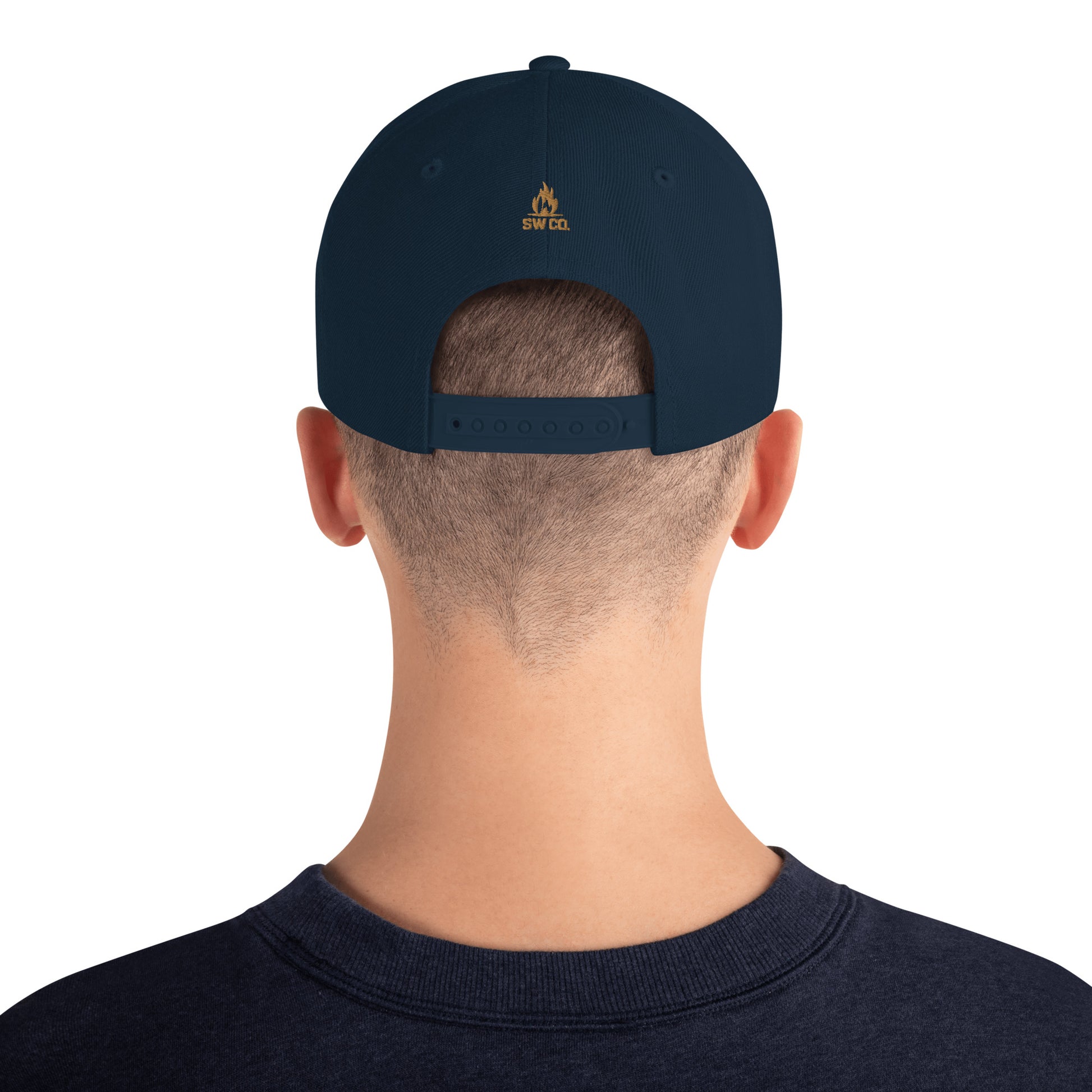 Back view of person wearing dark navy snapback cap with SW CO logo and adjustable strap