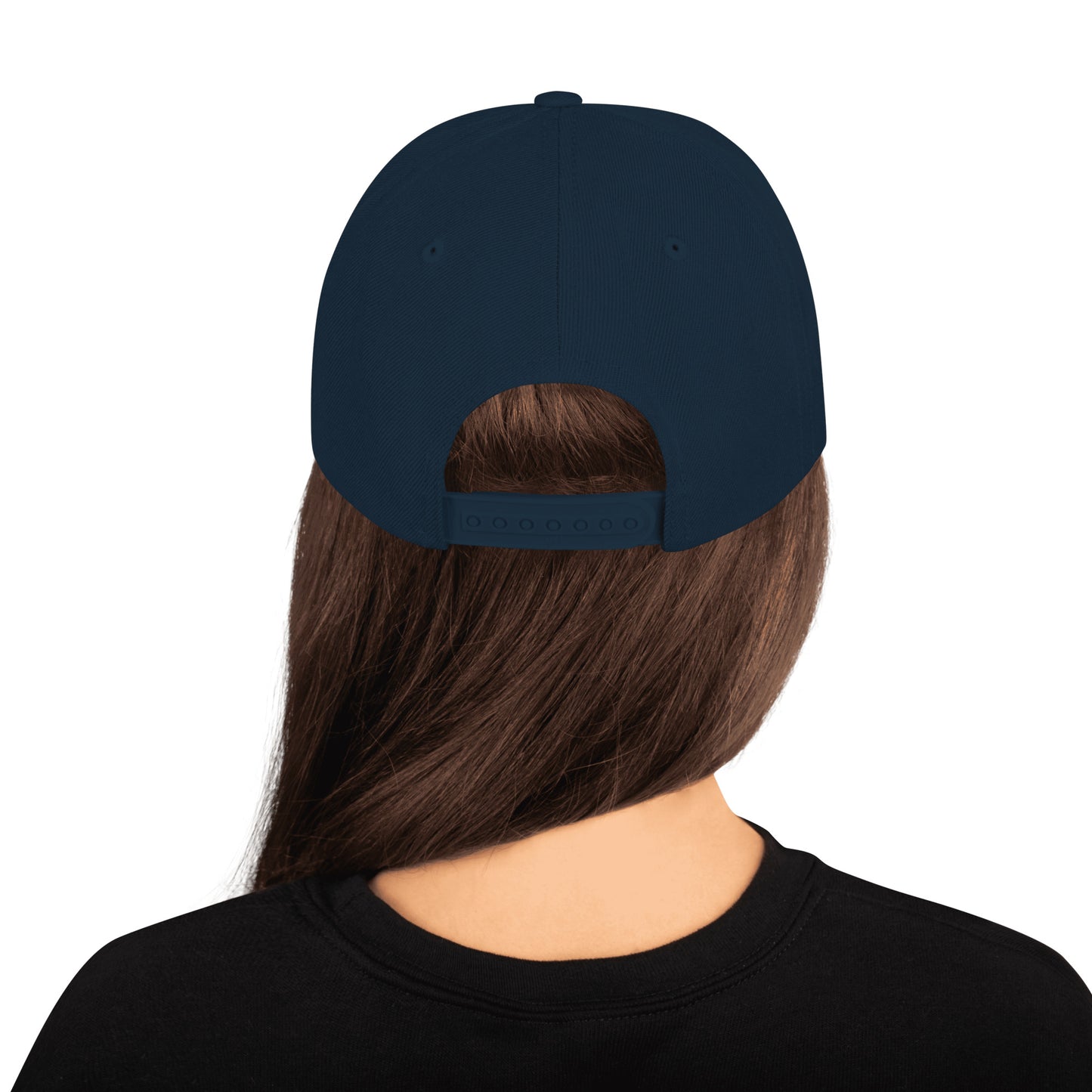 Back view of a person wearing a dark navy classic snapback cap with adjustable strap and long brown hair
