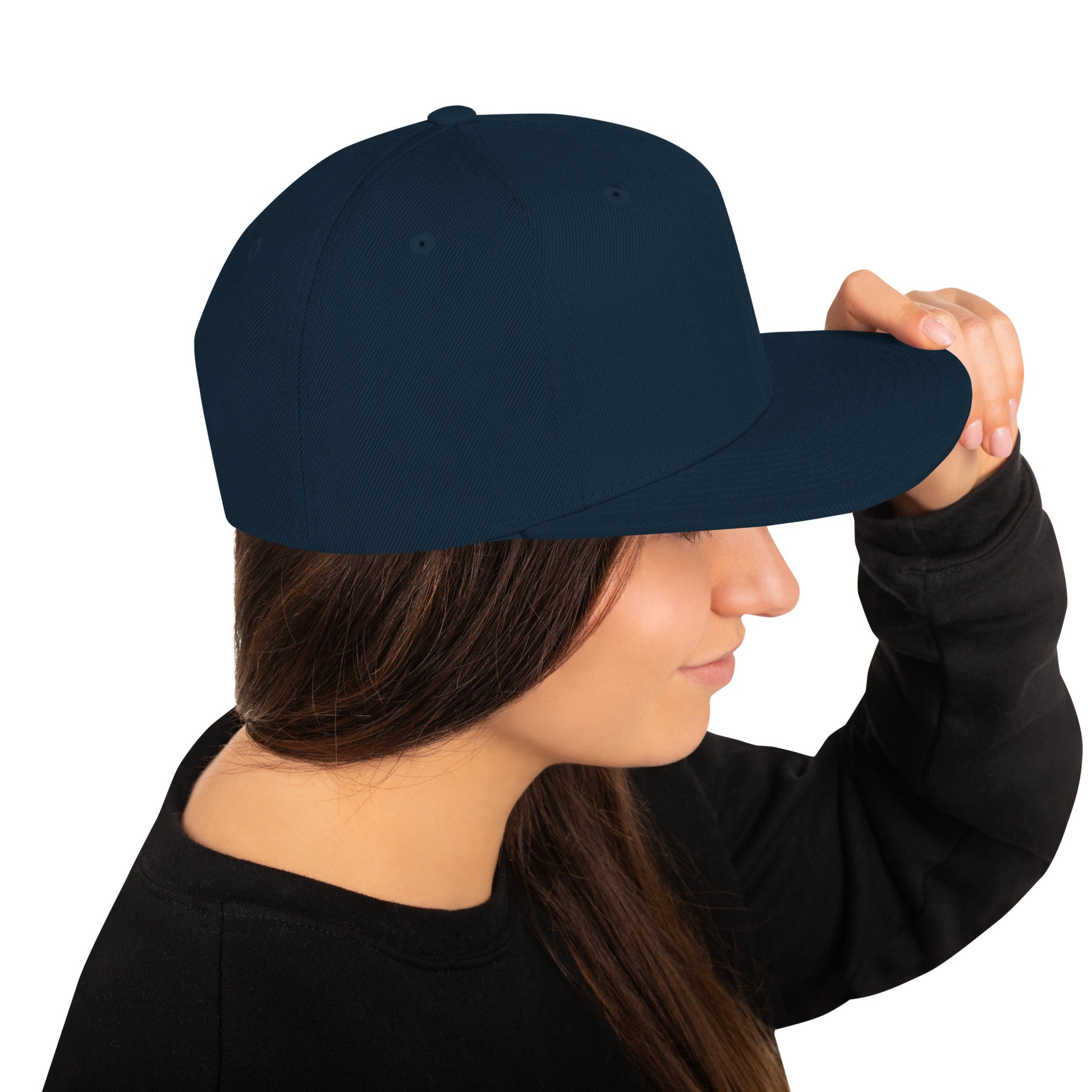 Woman wearing a dark navy classic snapback cap with flat bill, adjusting it with her hand