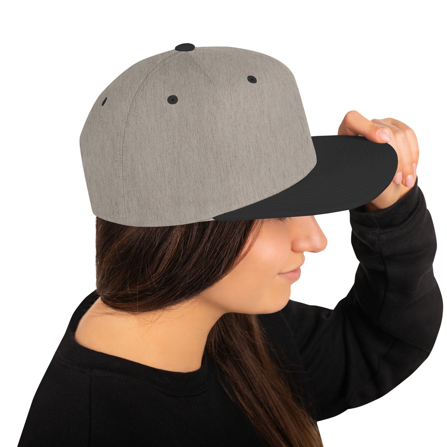 Heather black snapback cap worn by woman with long brown hair and black sweatshirt
