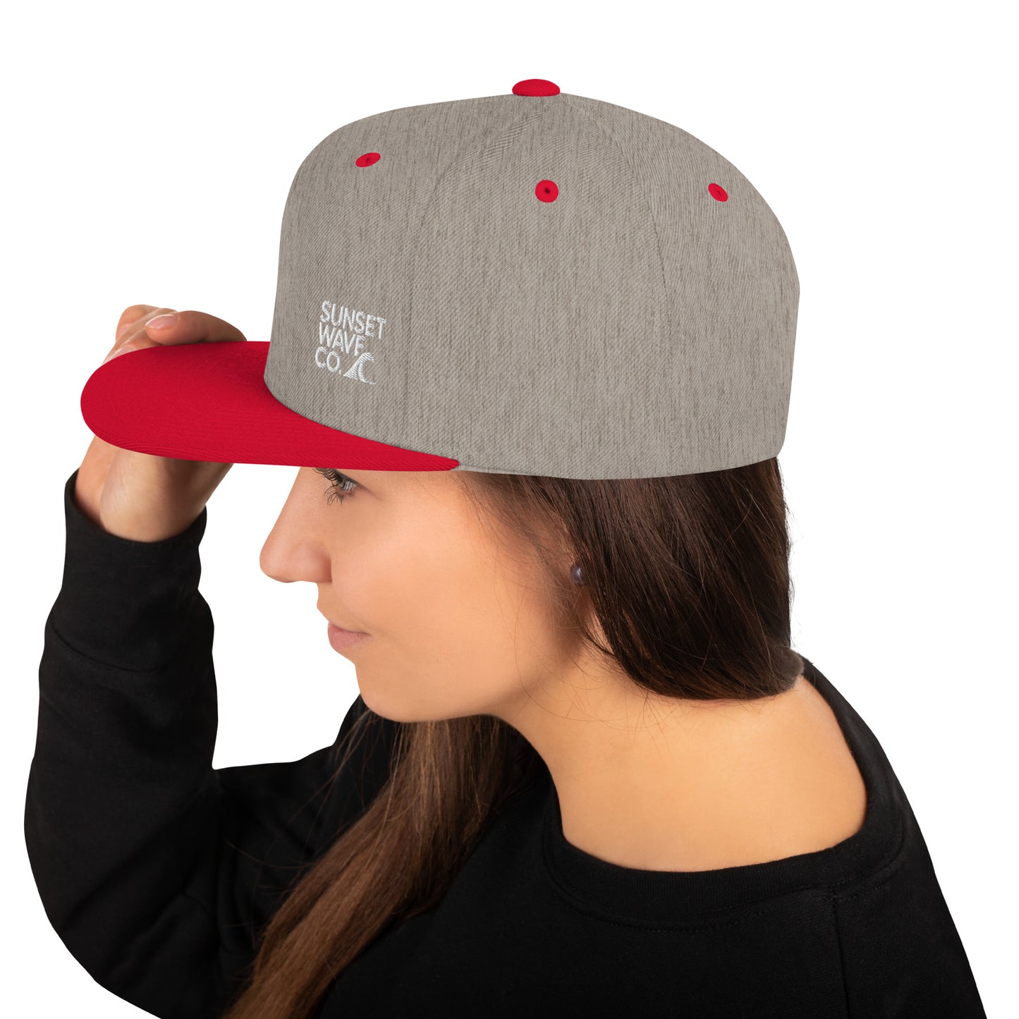 Heather grey and red classic snapback hat with Sunset Wave Co. logo worn by woman in black