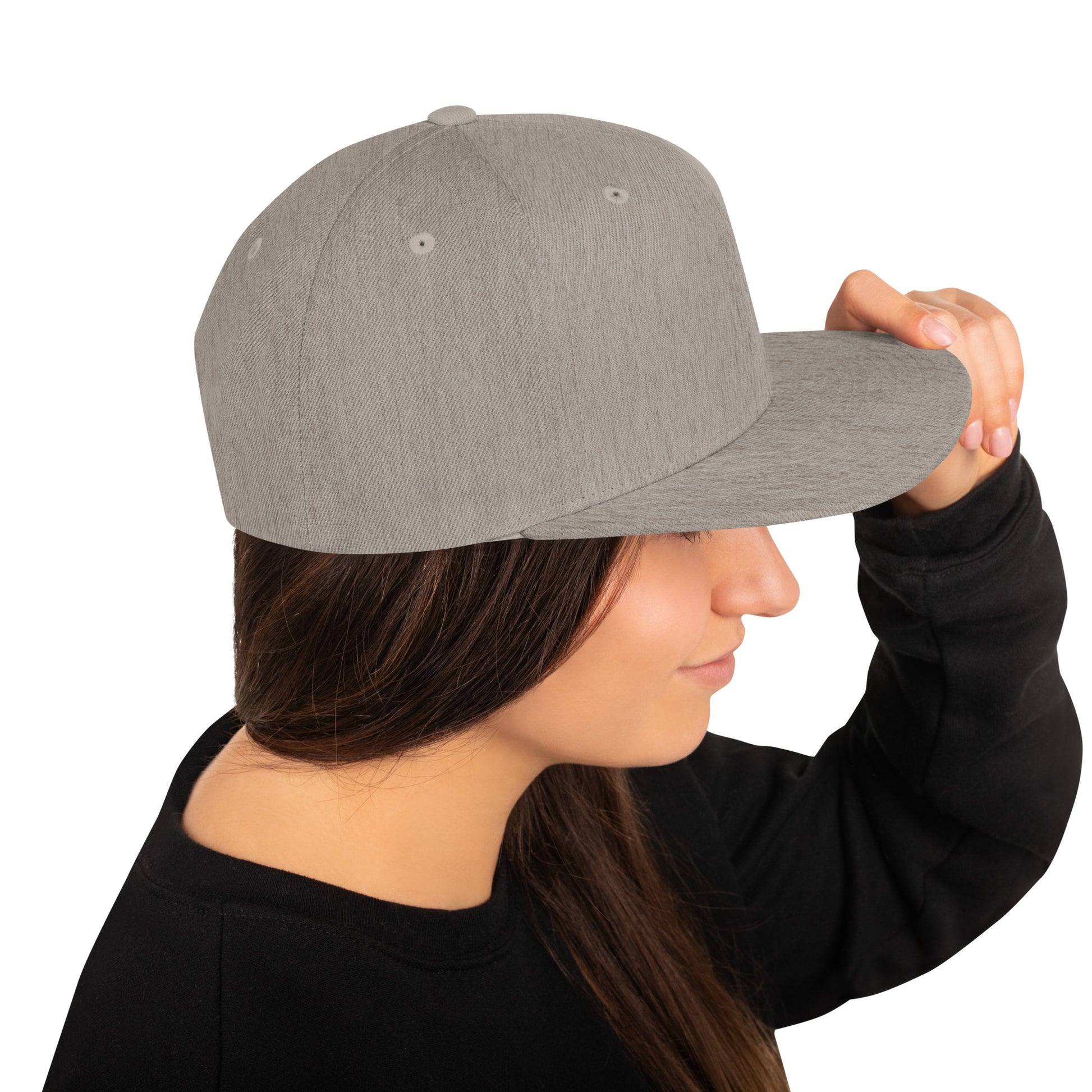 Heather grey classic snapback hat worn by woman in black sweatshirt, side view with hand adjusting brim