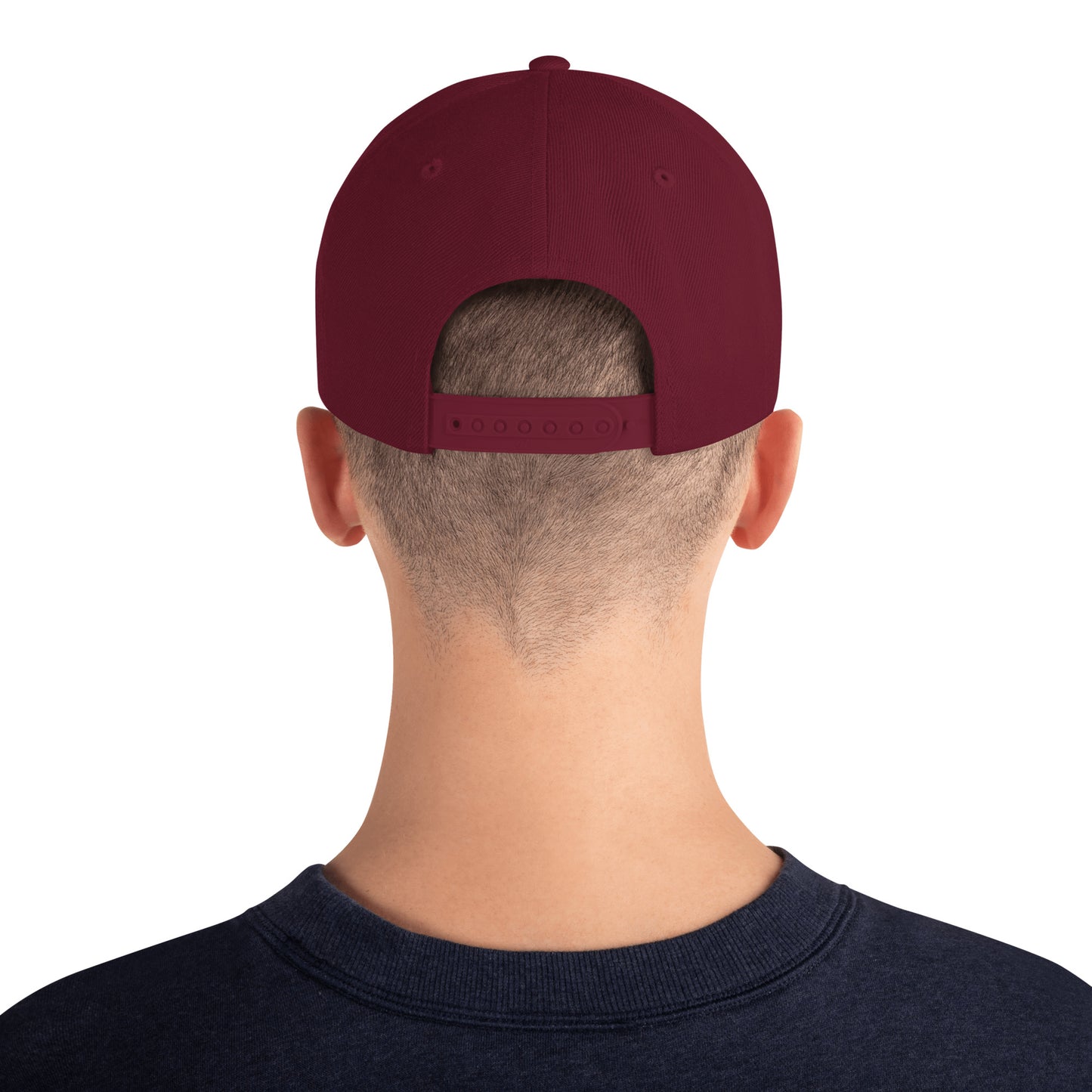 Back view of person wearing maroon classic snapback cap and navy sweatshirt on white background