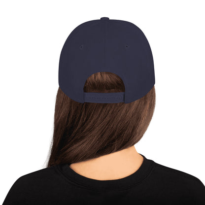 Back view of person wearing navy blue classic snapback hat with adjustable strap and long brown hair