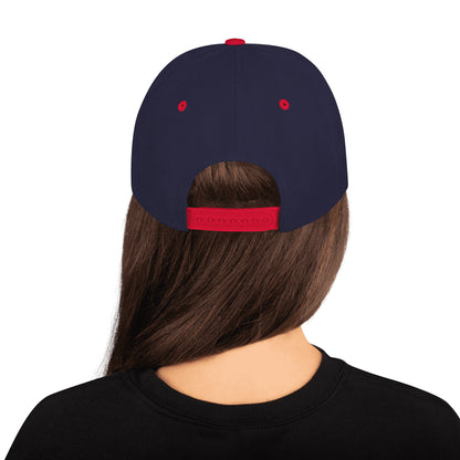 Rear view of a woman wearing a navy blue snapback cap with red adjustable strap and eyelets