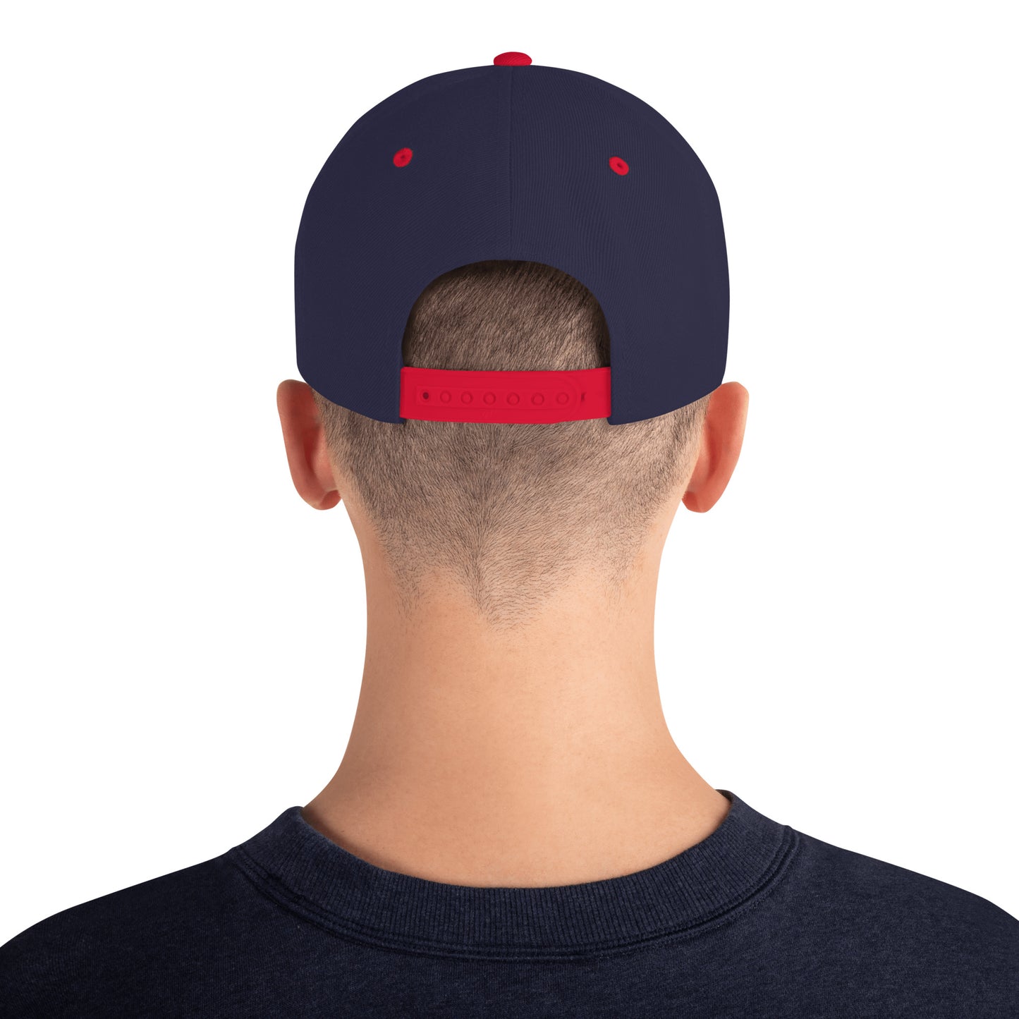 Back view of a person wearing a navy snapback cap with red adjustable strap and eyelets