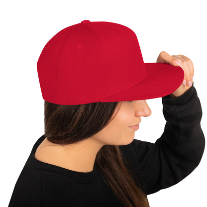 Side view of a woman wearing a plain red classic snapback cap with a flat brim
