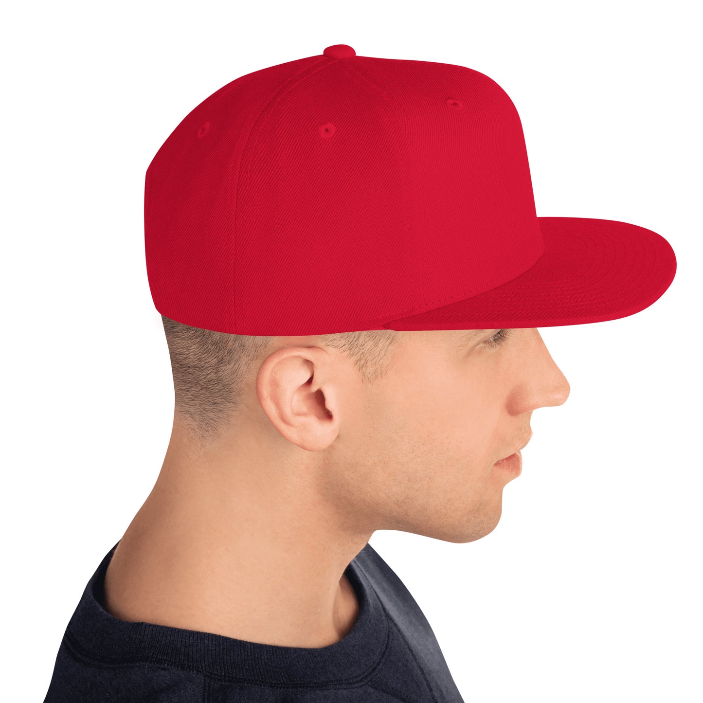 Side view of man wearing plain red classic snapback hat with flat brim and black shirt