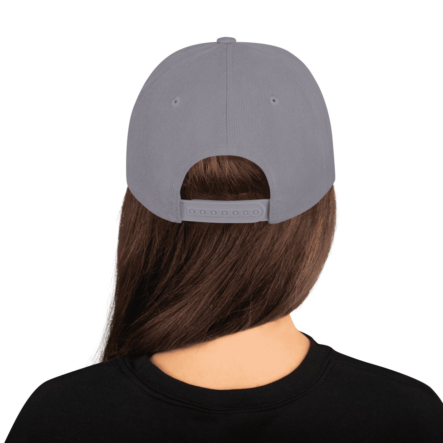 Back view of person wearing silver classic snapback cap with adjustable strap and long brown hair