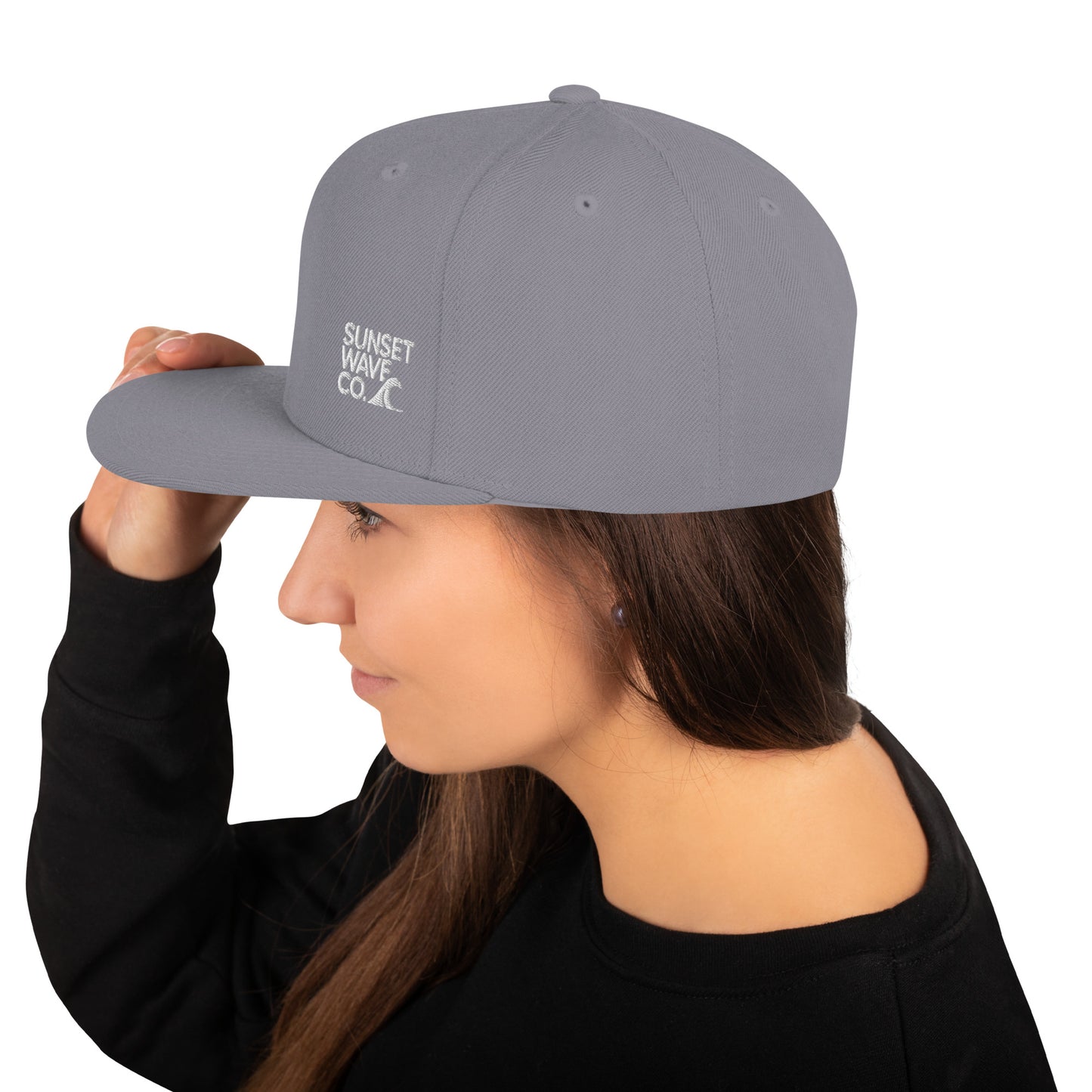 Woman wearing silver classic snapback hat with Sunset Wave Co logo on left side