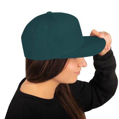 Side view of woman wearing spruce green classic snapback hat with flat bill and black sweater