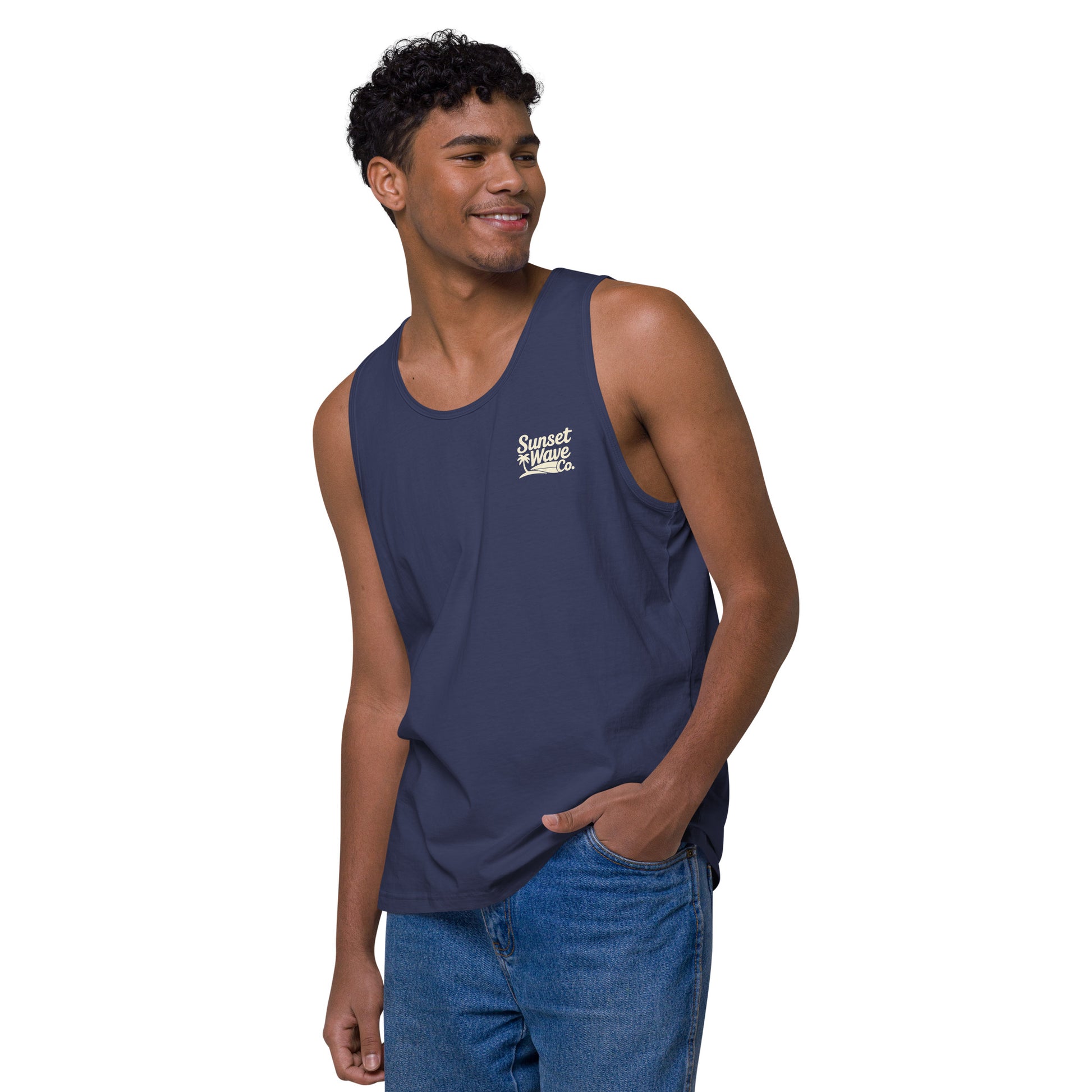 Smiling man wearing harbor blue tank top with Sunset Wave Co. logo and blue jeans