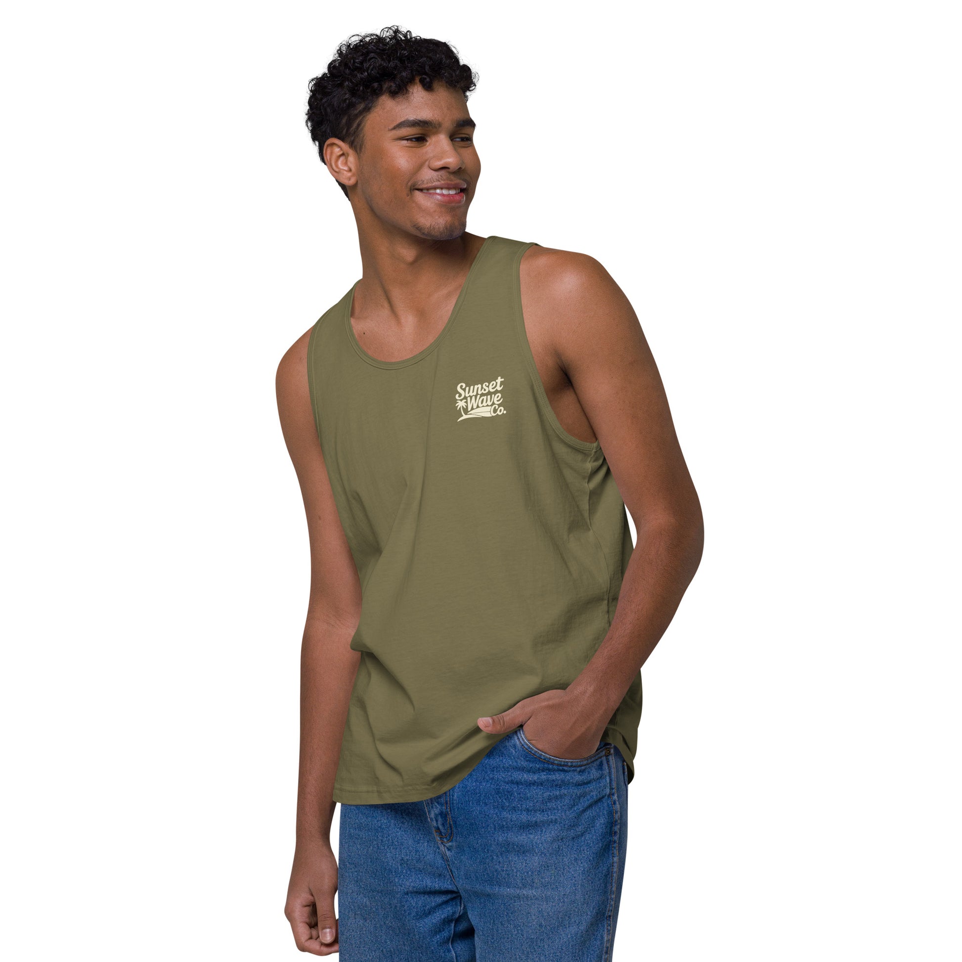 Smiling man wearing military green tank top with Sunset Wave Co. logo, paired with blue jeans