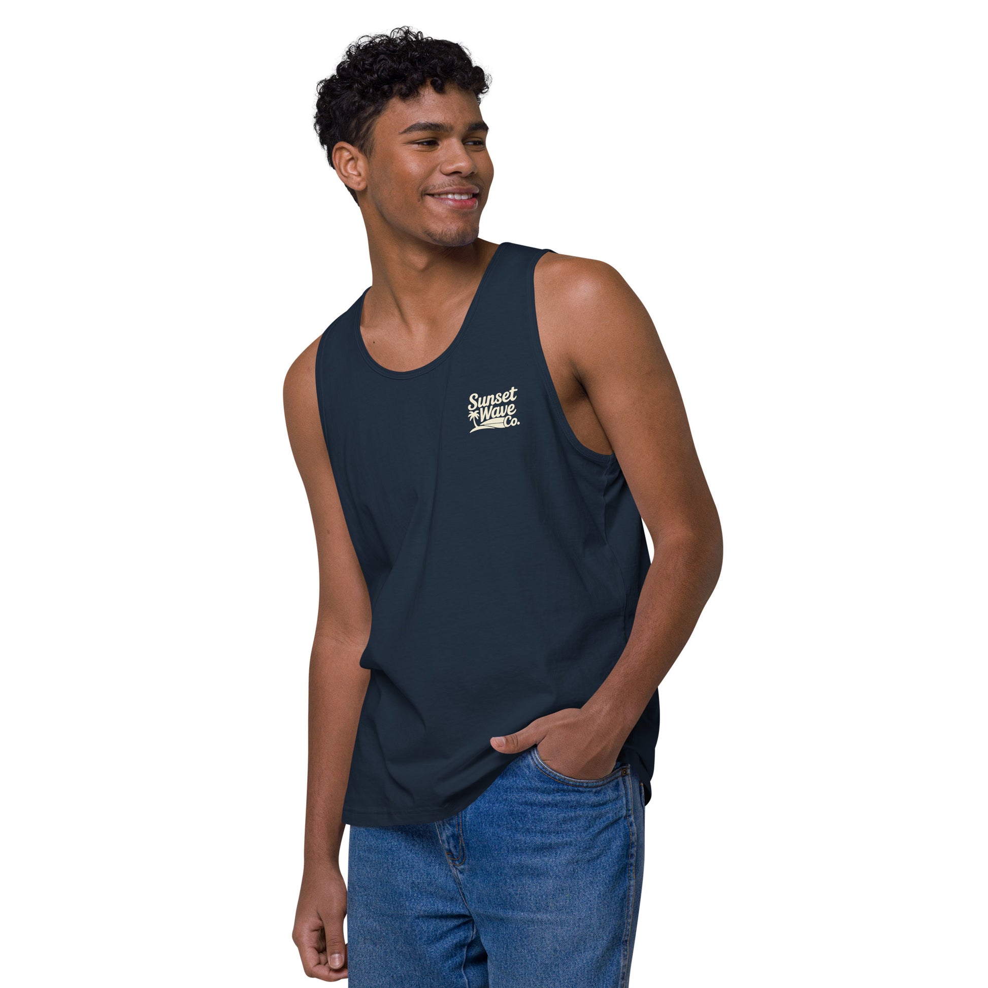 Smiling man wearing navy blue tank top with Sunset Wave Co. logo and blue jeans