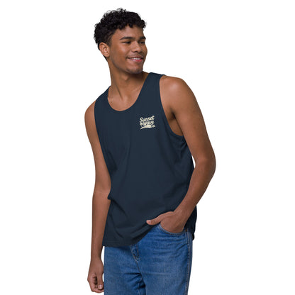 Smiling man wearing navy blue tank top with Sunset Wave Co. logo and blue jeans