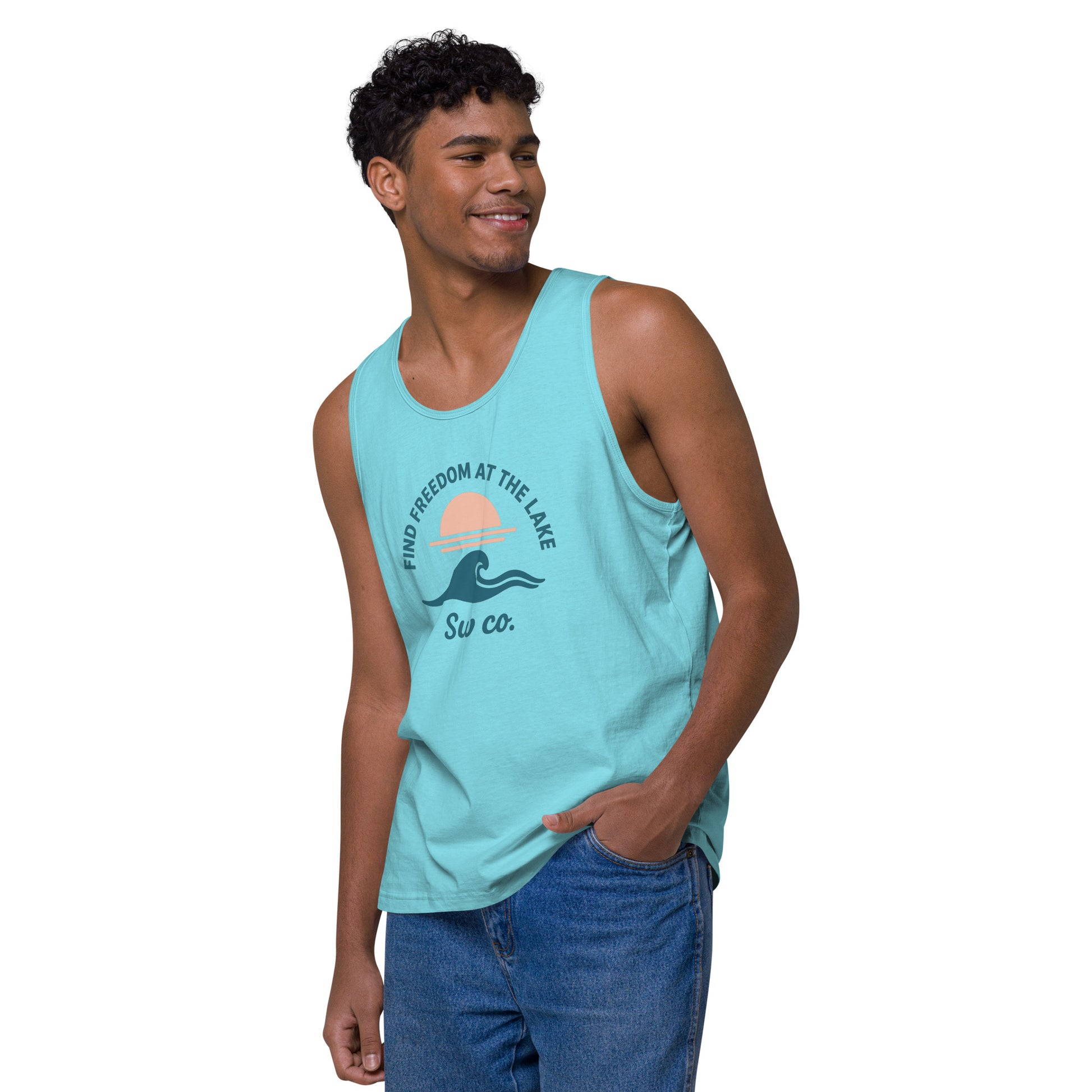 smiling young man wearing a pacific blue tank top with lake sunset wave print and blue jeans