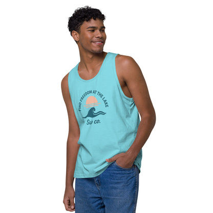 smiling young man wearing a pacific blue tank top with lake sunset wave print and blue jeans