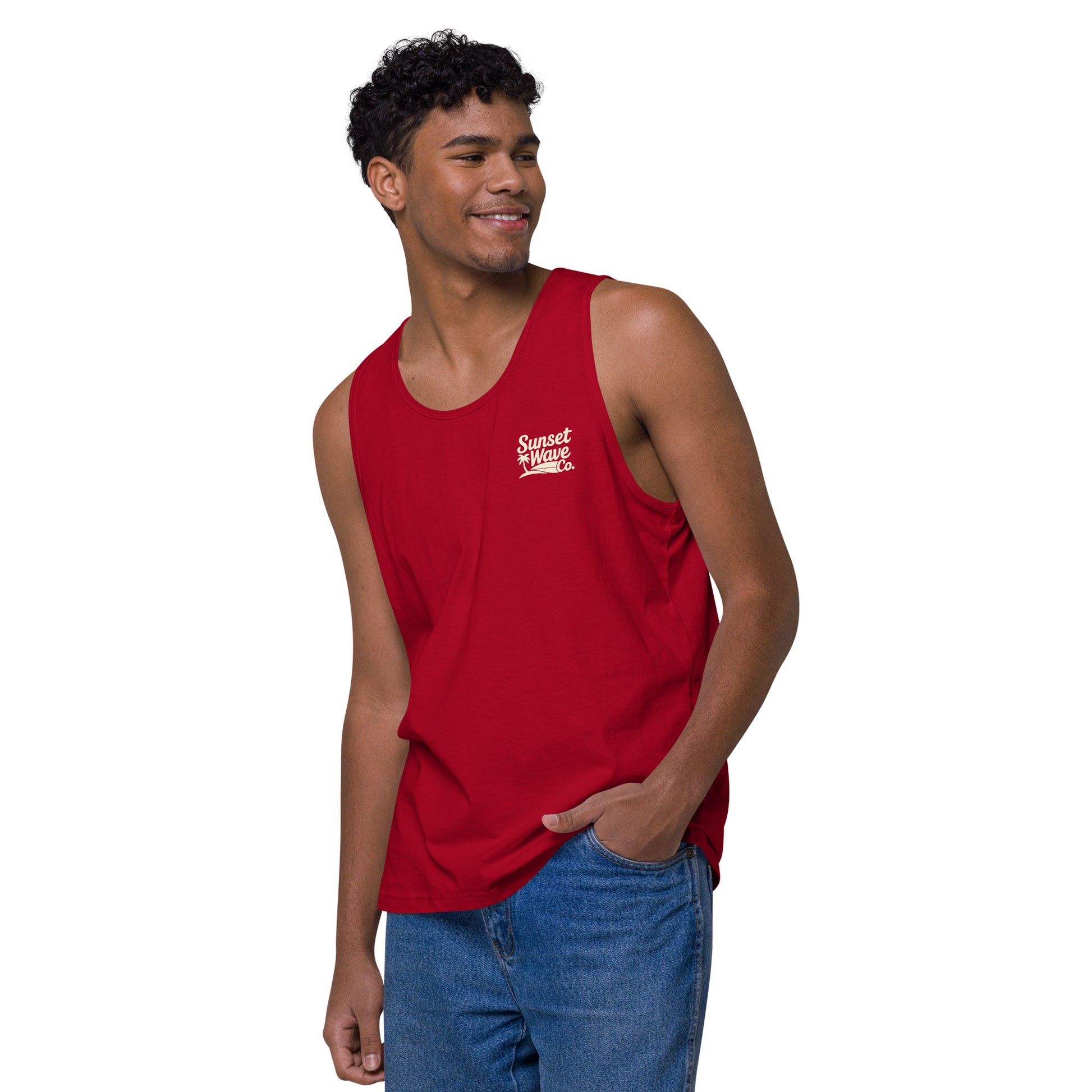 Smiling man wearing red Sunset Wave Co. tank top and blue jeans on white background