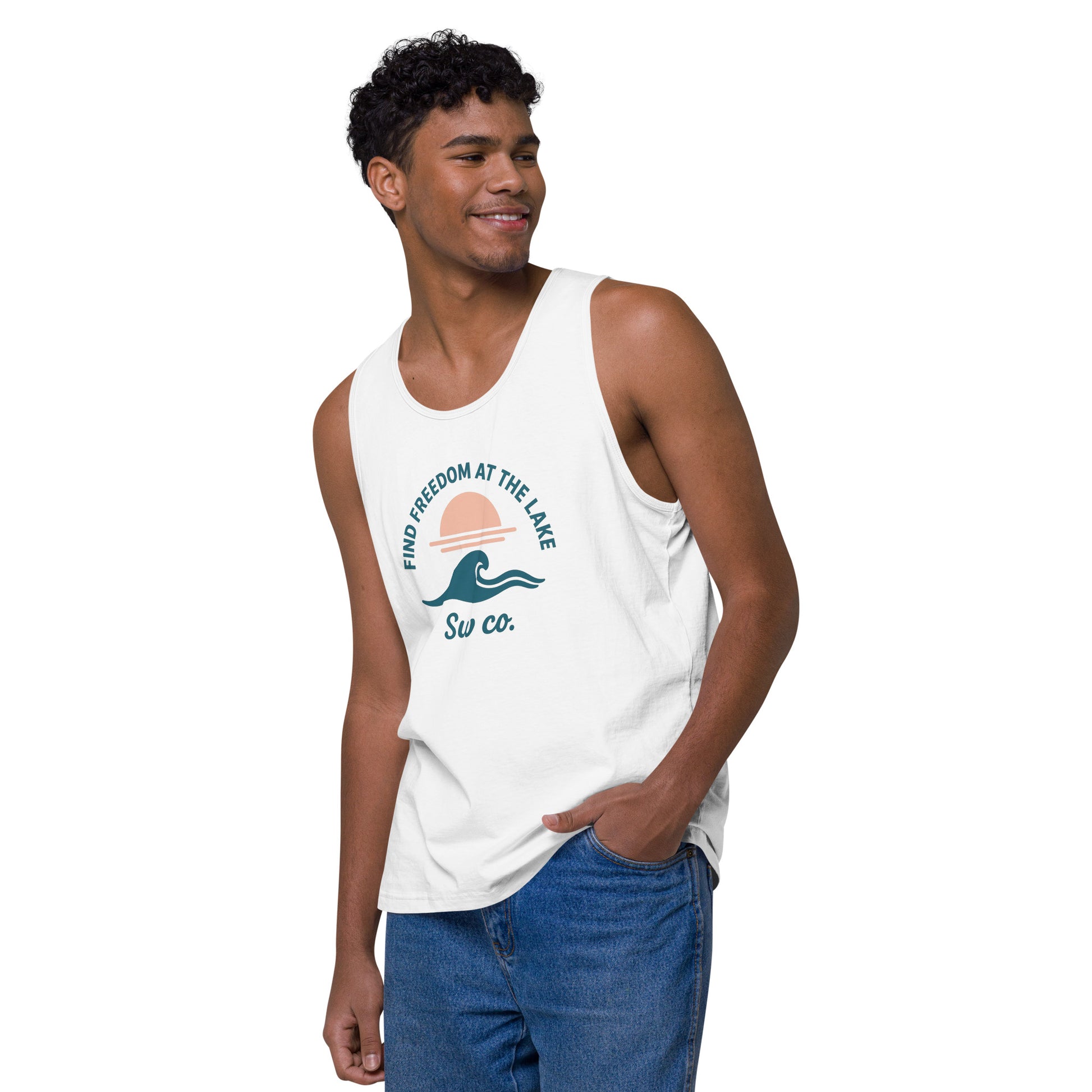 Man wearing white tank top with lake wave and sunset graphic and text, styled with blue jeans