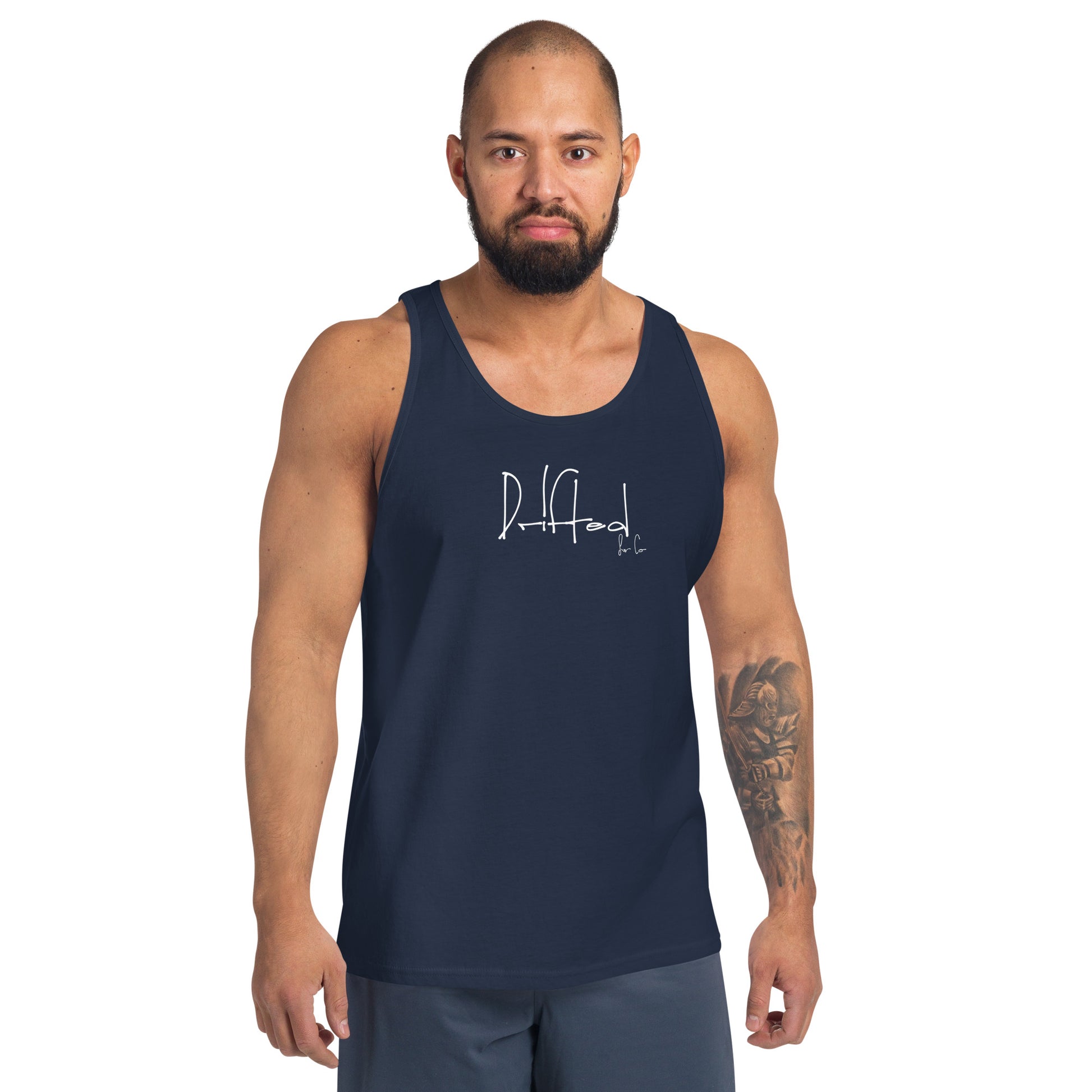 Man wearing a navy blue tank top with 'Drifted' text design on front, standing against white background