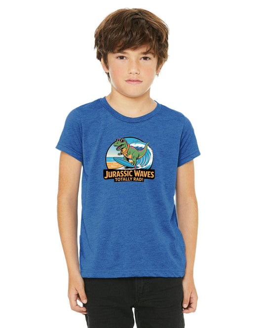 Boy wearing blue t-shirt with cartoon T-Rex surfing and text Jurassic Waves Totally Rad