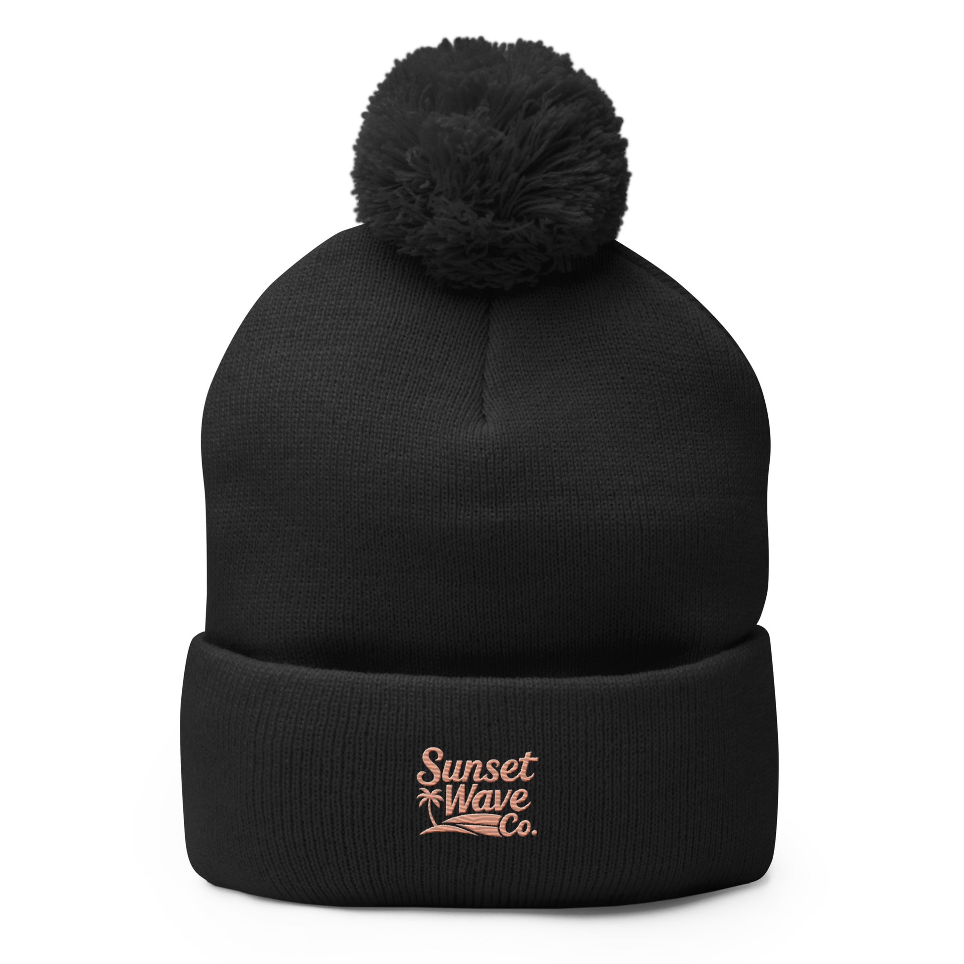 Black knit pom-pom beanie with folded brim and pink Sunset Wave Co. logo