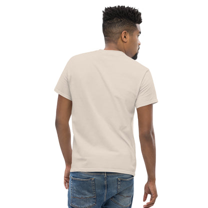 Man wearing a natural-colored unisex classic tee paired with blue jeans, shown from the back