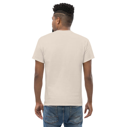 Man wearing natural color unisex classic t-shirt, viewed from back, paired with blue jeans on white background