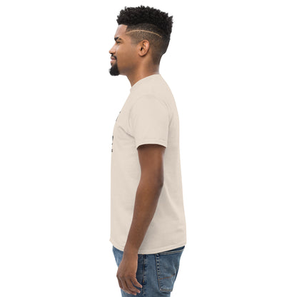 Side view of man wearing natural unisex classic tee and blue jeans against white background