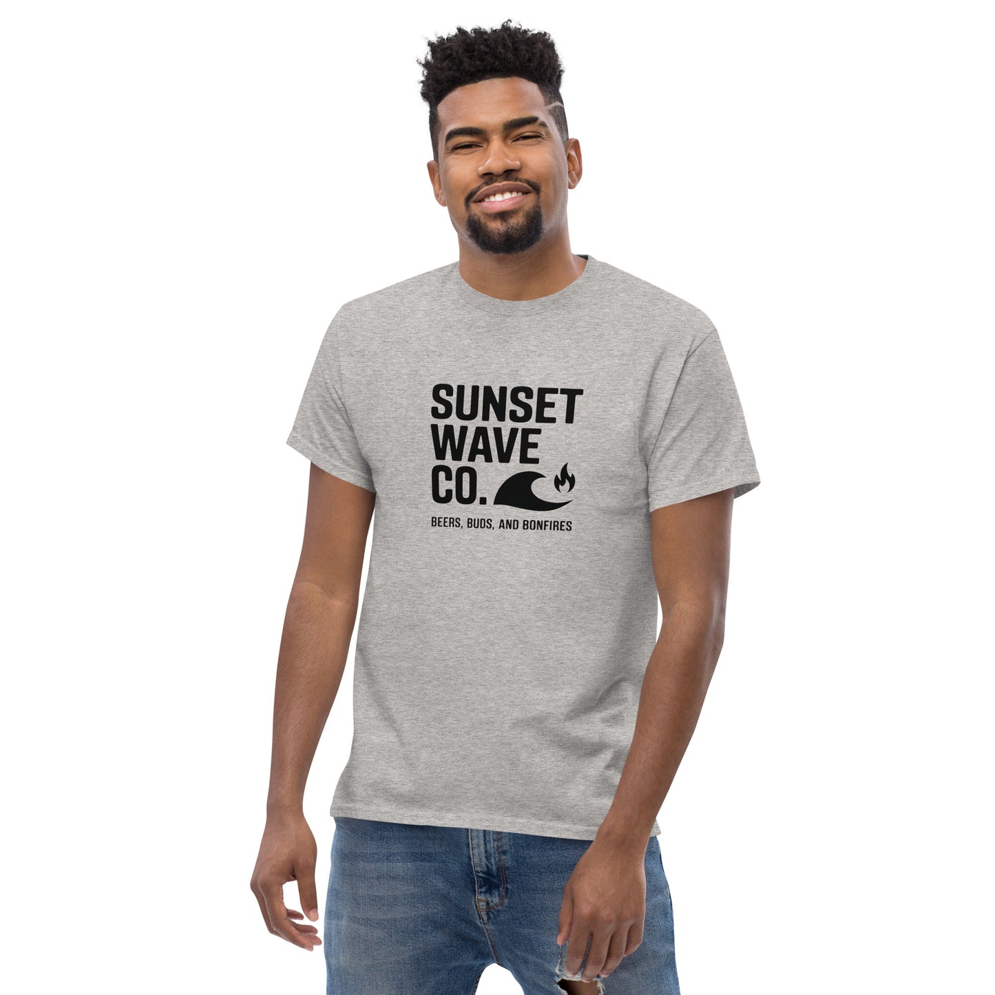 Smiling man wearing sport grey unisex classic tee with Sunset Wave Co. logo and text