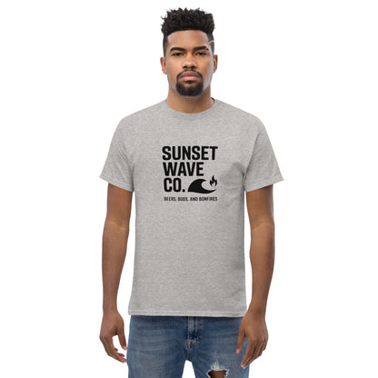 Man wearing sport grey Sunset Wave Co. t-shirt with wave and bonfire graphic, casual outfit