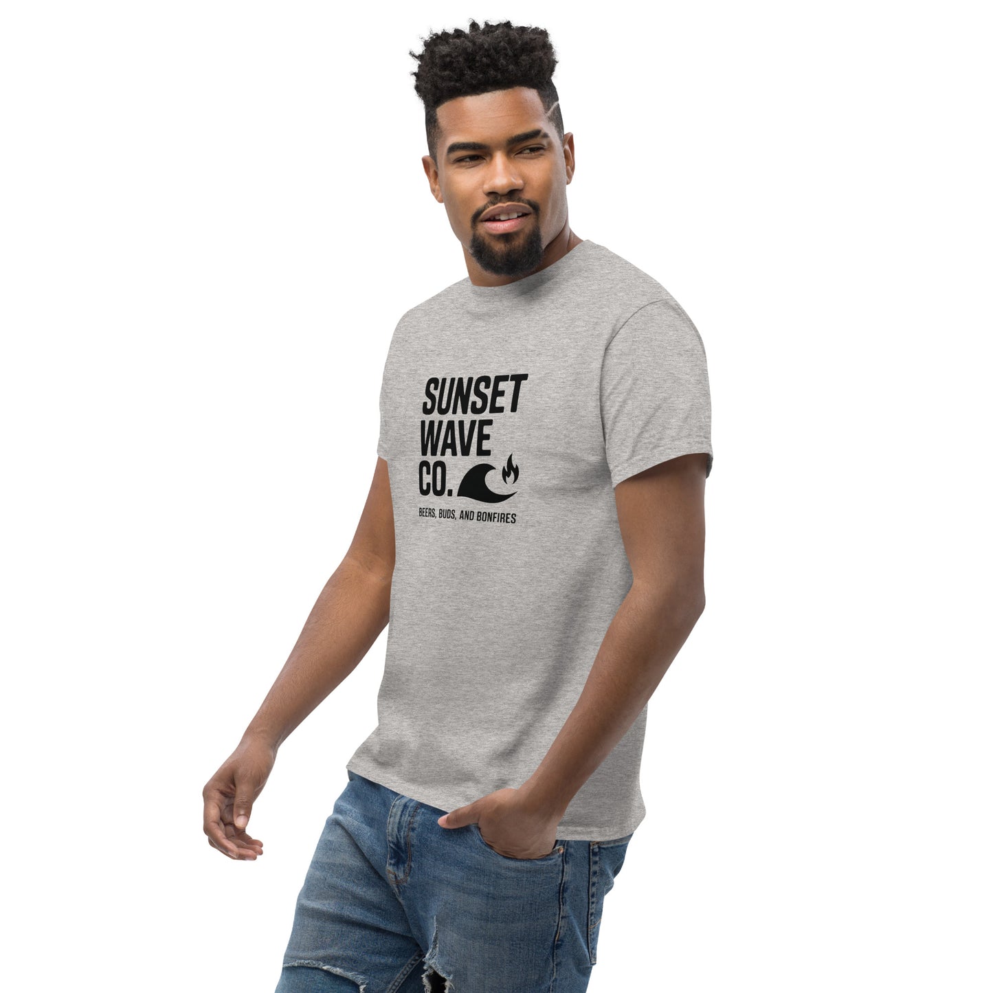 Man wearing sport grey unisex classic tee with Sunset Wave Co. logo and casual ripped jeans