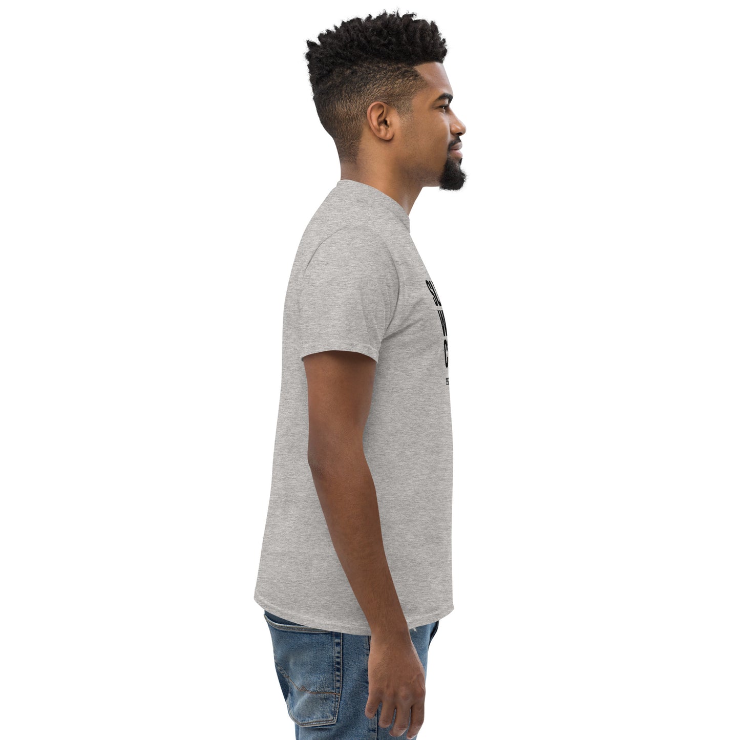 Side view of man wearing sport grey unisex classic t-shirt and blue jeans against white background