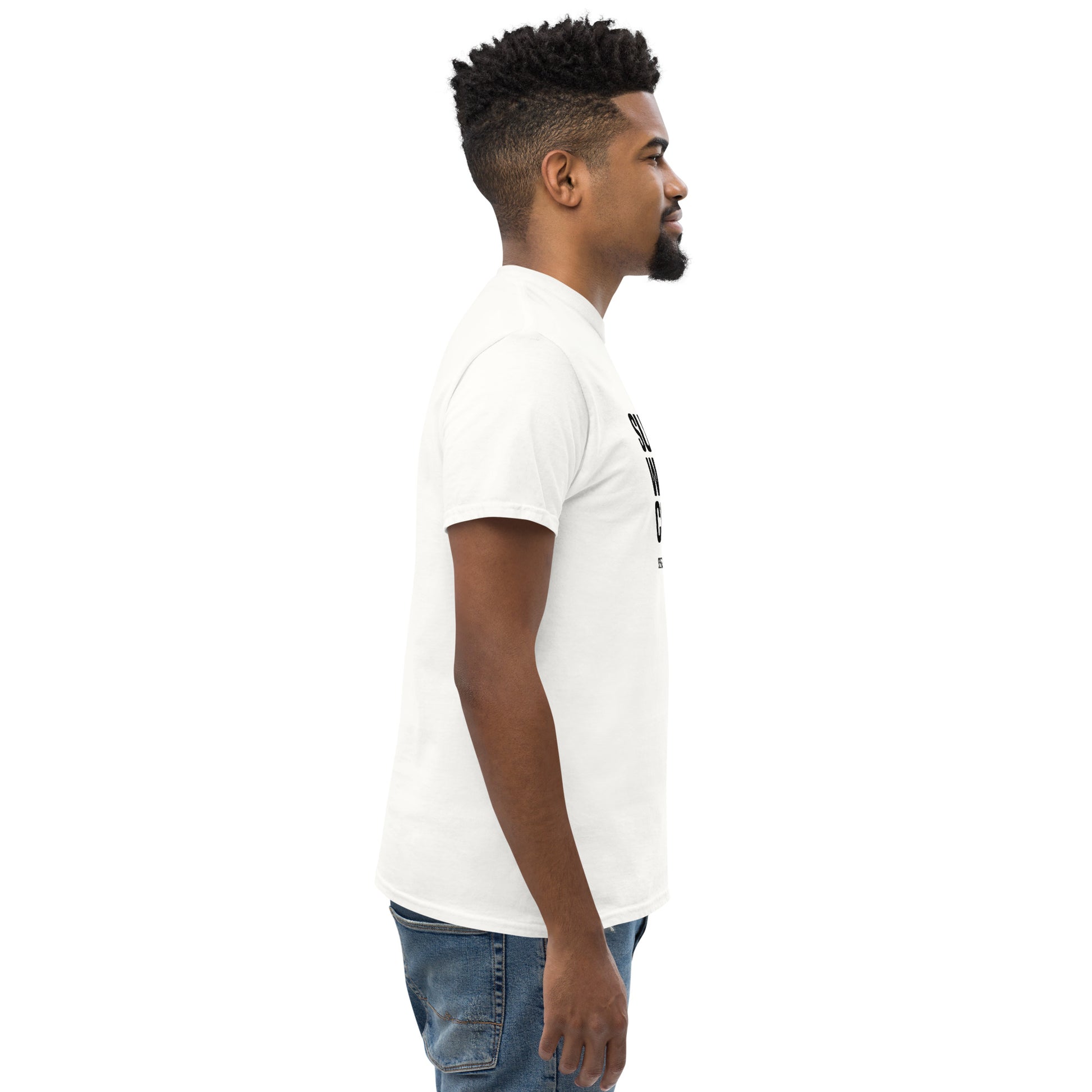 Side view of man wearing white unisex classic tee and blue jeans on white background