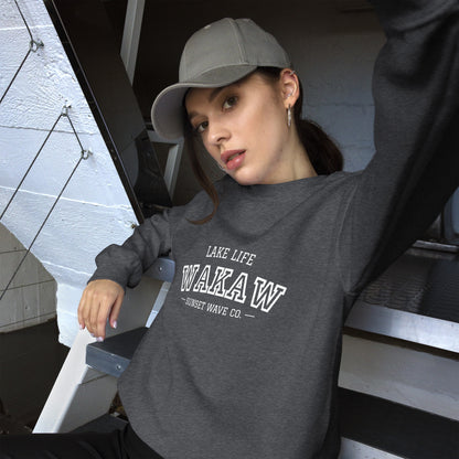 Woman wearing dark heather unisex crew neck sweatshirt with WAKA W lake life print and gray cap