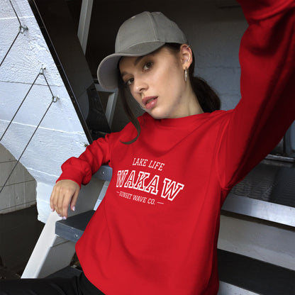 Young woman wearing a red unisex crew neck sweatshirt with white text and a gray baseball cap
