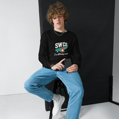 Young man wearing a black long sleeve tee with SWCo. graphic and slogan, blue jeans, white sneakers, holding a smartphone