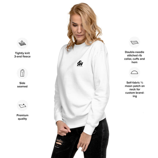Woman wearing white unisex premium sweatshirt with small black SW logo, styled with ripped black jeans