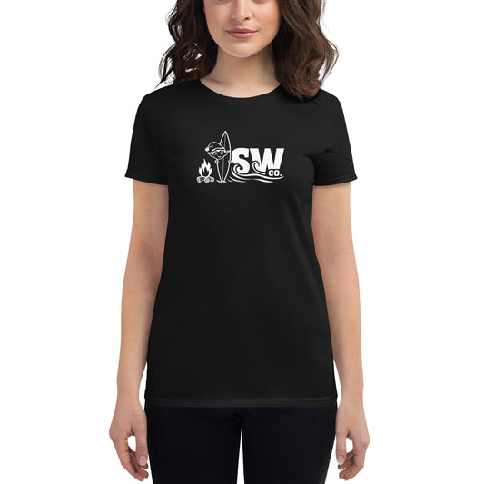 Woman wearing black fitted t-shirt with white SW Co. logo featuring campfire, surfboard, and waves
